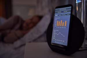 woman sleeping in bed with sleep data app running 2021 08 27 09 31 40 utc