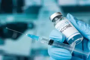 BOTTLE OF COVID-19 VACCINE WITH SYRINGE