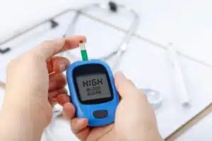 hand-holding-blood-glucose-meter-measuring-blood-sugar-